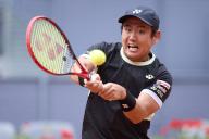 Yoshihito Nishioka of Japan returns a shot against Felix Auger-Aliassime of Canada during day four of the Mutua Madrid Open 2024 at Caja Magica on April 25, 2024, in Madrid, Spain