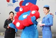 June 2, 2024, Tokyo, Japan - Japan Airlines (JAL) cabin attendants pose for photo with Myaku-Myaku (C), mascot of the 2025 World Expo Osaka\/Kansai before JAL\'s Myaku-Myaku jet designed with Myaku-Myaku at the JAL hangar of the Haneda airport in Tokyo on Sunday, June 2, 2024, cabin attendant (R) wears 70s uniformfor Expo 70. The new Myaku-Myaku jet will serve for the international route from June 3, while the first one was launched for the domestic route last year. (photo by Yoshio Tsunoda\/AFLO