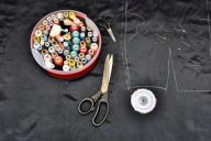 Creating clothing - pattern, scissors, fabric, thread and a set of pins