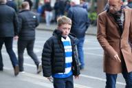 26th April 2024; Loftus Road Stadium, Shepherds Bush, West London, England; EFL Championship Football, Queens Park Rangers versus Leeds United; Young Queens Park Rangers fan and father arriving at the stadium ahead of the match