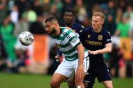 28th April 2024; Dens Park, Dundee, Scotland; Scottish Premiership Football, Dundee versus Celtic; Cameron Carter-Vickers of Celtic challenges for the ball with Scott Tiffoney of Dundee