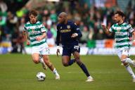 28th April 2024; Dens Park, Dundee, Scotland; Scottish Premiership Football, Dundee versus Celtic; Mohamad Sylla of Dundee takes on Matt OâRiley and Nicolas Kuhn of Celtic