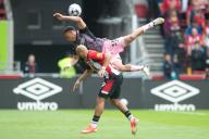 4th May 2024; Gtech Community Stadium, Brentford, London, England; Premier League Football, Brentford versus Fulham; Antonee Robinson of Fulham and Bryan Mbeumo of Brentford challenge for the