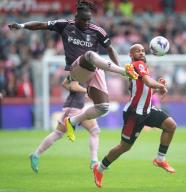 4th May 2024; Gtech Community Stadium, Brentford, London, England; Premier League Football, Brentford versus Fulham; Calvin Bassey of Fulham clears the ball under pressure by Bryan Mbeumo of Brentford
