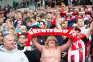 4th May 2024; Gtech Community Stadium, Brentford, London, England; Premier League Football, Brentford versus Fulham; Brentford fans raise their scarves in support of the