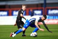 18th May 2024; Dens Park, Dundee, Scotland: Scottish Premiership Football, Dundee versus Kilmarnock; Liam Donnelly of Kilmarnock is tackled by Lyall Cameron of Dundee
