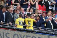18th May 2024; Wembley Stadium, London, England; EFL League One Play Off Football Final, Bolton Wanderers versus Oxford United; Elliott Moore and Billy Bodin of Oxford United are congratulated by the club co-owners Horst Geicke, Zaki Nuseibeh, Sumrith Thanakarnjanasuth, and Erick Thohir
