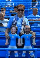 19th May 2024; Etihad Stadium, Manchester, England; Premier League Football, Manchester City versus West Ham United; a Manchester City fan poses with inflatable dolls of Kevin de Bruyne and Manchester City manager Pep Guardiola