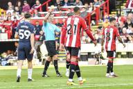 19th May 2024; Bramall Lane, Sheffield, England; Premier League Football, Sheffield United versus Tottenham Hotspur; Referee Andy Madley issues a yellow card to Jack Robinson of Sheffield for a bad