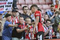19th May 2024; Bramall Lane, Sheffield, England; Premier League Football, Sheffield United versus Tottenham Hotspur; Oliver Arblaster of Sheffield gives his boots to a young