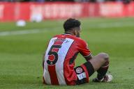 19th May 2024; Bramall Lane, Sheffield, England; Premier League Football, Sheffield United versus Tottenham Hotspur; Auston Trusty of Sheffield is exhausted after the final