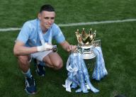 19th May 2024; Etihad Stadium, Manchester, England; Premier League Football, Manchester City versus West Ham United; Phil Foden of Manchester City poses with his medal and the Premier League trophy