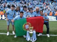 19th May 2024; Etihad Stadium, Manchester, England; Premier League Football, Manchester City versus West Ham United; Matheus Nunes of Manchester City and his friend pose for a photo with the Premier League trophy and the Portuguese national