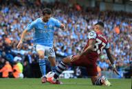 19th May 2024; Etihad Stadium, Manchester, England; Premier League Football, Manchester City versus West Ham United; Bernardo Silva of Manchester City is tackled by Emerson Palmieri of West Ham