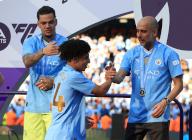 19th May 2024; Etihad Stadium, Manchester, England; Premier League Football, Manchester City versus West Ham United; Manchester City manager Pep Guardiola shakes hands with Rico Lewis during the medal presentation