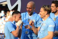 19th May 2024; Etihad Stadium, Manchester, England; Premier League Football, Manchester City versus West Ham United; Manchester City manager Pep Guardiola with Phil Foden and Jack Grealish during the medal presentation