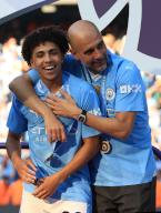 19th May 2024; Etihad Stadium, Manchester, England; Premier League Football, Manchester City versus West Ham United; Manchester City manager Pep Guardiola with Rico Lewis during the medal