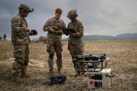 U.S. Army Capt. Timothy Naudet, center, assigned to the Artificial Intelligence Integration Center works with Pvt. Carlos Fletes, left, and Sgt. Claudia Kinney, right, assigned to the 6th Squadron, 8th Cavalry Regiment, to add new software to a drone during Allied Spirit 24 at the Hohenfels Training Area, Joint Multinational Readiness Center, Germany, March 6, 2024. Allied Spirit 24 is a U.S. Army exercise for its NATO Allies and partners at the Joint Multinational Readiness Center near Hohenfels, Germany. The exercise develops and enhances NATO and key partners interoperability and readiness across specified warfighting functions. (U.S. Army photo by Spc. Micah Wilson