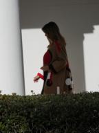 Washington, DC 11/20/18 Melania Trump wearing Christian Dior coat from the pre-fall 2018 collection walks down the White House colonnade to participate in the Thanksgiving event . Photo by Dennis