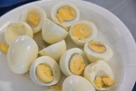 Many halved eggs served in plate on Passover Jewish Holiday.Egg a traditional food of mourning, symbolizes cycle of life expresses mourning for the destruction of the Temple and the lack of sacrifices