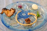 Traditional Seder plate on Passover Jewish Holiday, with six items which have significance to the retelling of the story of Passover - the exodus from Egypt, which is the focus of this ritual meal