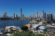 Aerial drone landscape view of luxury house against Surfers Paradise city skyline in Gold Coast Queensland, Australia