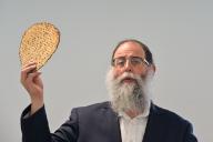 BRISBANE - APR 18 2024:Rabbi bless Matzah Unleavened flatbread on Passover Seder, a feast that includes reading the Haggadah, Book of Exodus about God bringing the Israelites out of slavery in Egypt