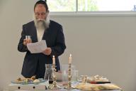 BRISBANE - APR 18 2024:Rabbi blessing on wine and grape on Passover Seder, a feast that includes reading the Haggadah, Book of Exodus about God bringing the Israelites out of slavery in Egypt