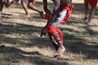 LAURA,QLD - JULY 08 2023:Indigenous Australians men on ceremonial dance in Laura Quinkan Dance Festival Cape York Australia. Ceremonies combine dance, song, rituals, body decorations and
