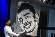 Artist Ange Hillz holds up his portrait of Daunte Wright that he painted live on stage during his funeral at Shiloh Temple International Ministries in Minneapolis, Minn., U.S., on Thursday, April 22, 2021. Wright was shot by police officer Kimberly Ann Potter who claims she thought she was deploying a taser when Wright attempted to flee as police attempted to place him under arrest for an outstanding warrant during a traffic stop. Credit: Samuel Corum 