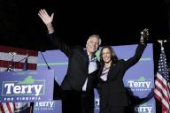 United States Vice President Kamala Harris, right, and Terry McAuliffe, the Democratic Party nominee for Governor of Virginia, left, wave to the crowd at his campaign event in Dumfries, Virginia on Thursday, October 21, 2021. Credit: Yuri Gripas / Pool via