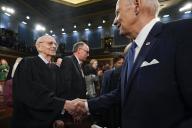 President Joe Biden shakes hands with retired Justice Stephen Breyer the State of the Union address to a joint session of Congress at the Capitol, Tuesday, Feb. 7, 2023, in Washington. Credit: Jacqueline Martin / Pool via