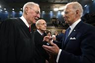 President Joe Biden talks with retired Justice Anthony Kennedy after the State of the Union address to a joint session of Congress at the Capitol, Tuesday, Feb. 7, 2023, in Washington. Retired Justice Stephen Breyer is at center. Credit: Jacqueline Martin / Pool via