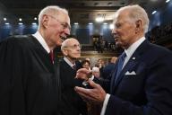 President Joe Biden talks with retired Justice Anthony Kennedy as retired Justice Stephen Breyer looks on after the State of the Union address to a joint session of Congress at the Capitol, Tuesday, Feb. 7, 2023, in Washington. Credit: Jacqueline Martin / Pool via