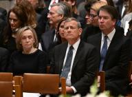 Chief Justice of the United States John G. Roberts, Jr. (C), his wife Jane Sullivan and Associate Justice Brett Kavanaugh (R) attend the memorial service for former Associate Justice of the Supreme Court Sandra Day O