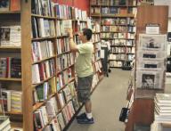 Cambridge, Massachusetts USA August 1, 2014 A patron browses among stacks at the Harvard Book Store. This establishment is independent and locally owned. New and used books are sold. Chris Fitzgerald / Candidate