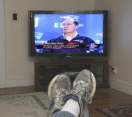 Millis, Massachusetts USA 01-22-2015 Taped press conference with Bill Belichick, head coach of the New England Patriots, appears on a television in a living room. Belichick denied knowledge of footballs being deflated during a rainy AFC championship ...