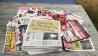 Millis, Massachusetts November 24, 2016 Pile of advertisements removed from inside a Boston Globe newspaper (foreground) on Thanksgiving Day. Most ads publicize sales on Black Friday, occurring on the following day. Many ads display red and green ...