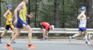 Wellesley, Massachusetts USA: April 17, 2017 A runner ties his shoelaces during the Boston Marathon. Chris Fitzgerald/CandidatePhotos/Newscom