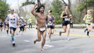 Wellesley, Massachusetts USA: April 17, 2017 John Glen Raines, a.k.a, the Barefoot Caveman, competes in the Boston Marathon. He runs marathons with little attire and without footwear. Chris Fitzgerald/CandidatePhotos/Newscom