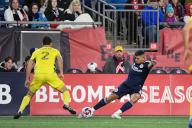 March 18, 2023: New England Revolution forward Gustavo Bou (7) gets a pass by Nashville SC defender Daniel Lovitz (2) during the first half in Foxborough Massachusetts. Eric Canha