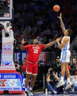 March 16, 2024: Carolina Tarheels Forward (5) Armando Bacot takes a shot over NC State Wolfpack Forward (30) DJ Burns, Jr. during the championship game of the ACC Men