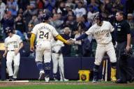 April 26, 2024: Milwaukee Brewers catcher William Contreras (24) scores and is congratulated by teammate first base Rhys Hoskins (12) during the game between the Milwaukee Brewers and the New York Yankees at American Family Field in Milwaukee, WI. Darren Lee\/CSM (Credit Image: Darren Lee\/Cal Sport Media