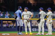 April 29, 2024: Tampa Bay Rays shortstop Niko Goodrum (0) waits with Milwaukee Brewers shortstop Willy Adames (27), second base Brice Turang (2), and first base Jake Bauers (9) as the Rays challenged an out call on a caught stealing in the seventh inning during the game between the Milwaukee Brewers and the Tampa Bay Rays at American Family Field in Milwaukee, WI. Darren Lee\/CSM (Credit Image: Darren Lee\/Cal Sport Media