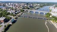An aerial view of Knoxville, Tennessee reveals a vibrant cityscape with a mix of historic and modern buildings, the Tennessee River weaving through downtown, lush green parks, and the distant Smoky Mountains framing the horizon.(Credit Image: Â Walter G Arce Sr Grindstone Medi/Cal Sport Media