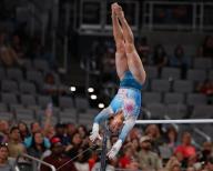 May 31, 2024: Leanne Wong transitions between the uneven bars during the Woman