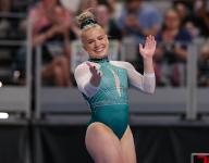 June 2, 2024: Joscelyn Roberson smiles after completing her beam routine during the Woman