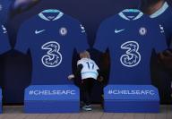 October 5, 2022, London, United Kingdom: London, England, 5th October 2022. A young fan looks behind some replica shirts outside the stadium before the UEFA Champions League match at Stamford Bridge, London