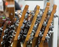 Finished guitar necks await attachment to guitar bodies in the Taylor Guitar factory in Tecate, Mexico