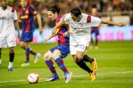 Intense duel as Messi and Adriano vie for the ball in Sevilla-Barcelona match